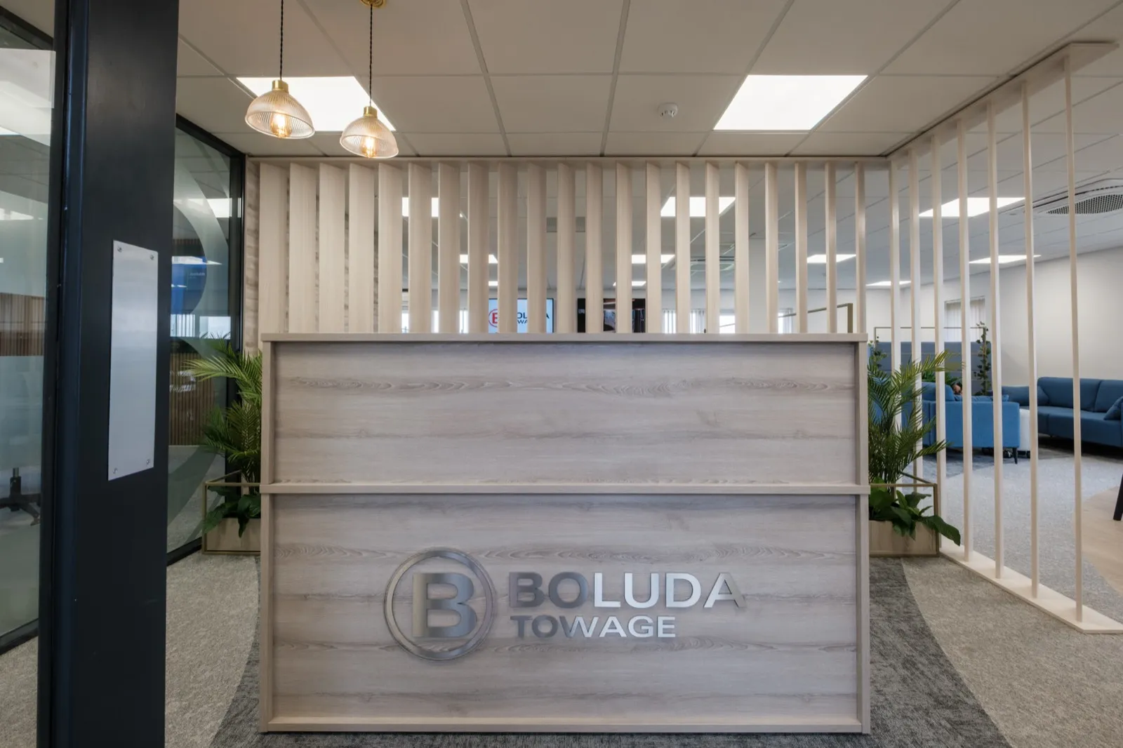 Boluda Towage reception desk with branded signage and timber slat screen